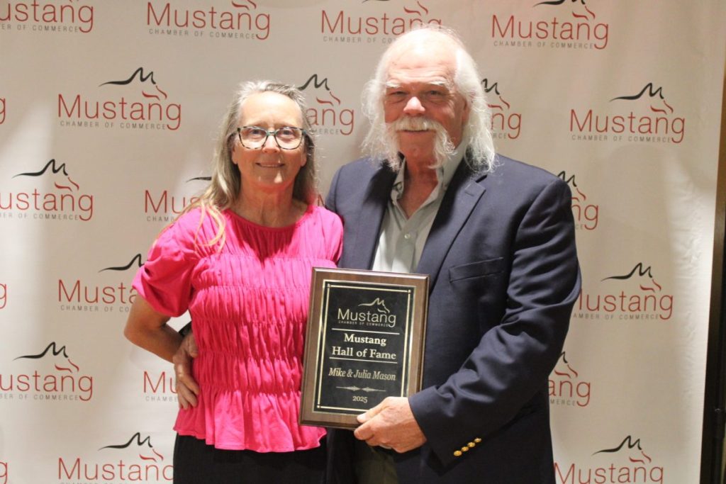 Mike and Julia Mason hold their plaque following the Mustang HOF announcement at Mustang's Chamber of Commerce Awards Banquet April 24. (Photo by Jacob Sturm) 