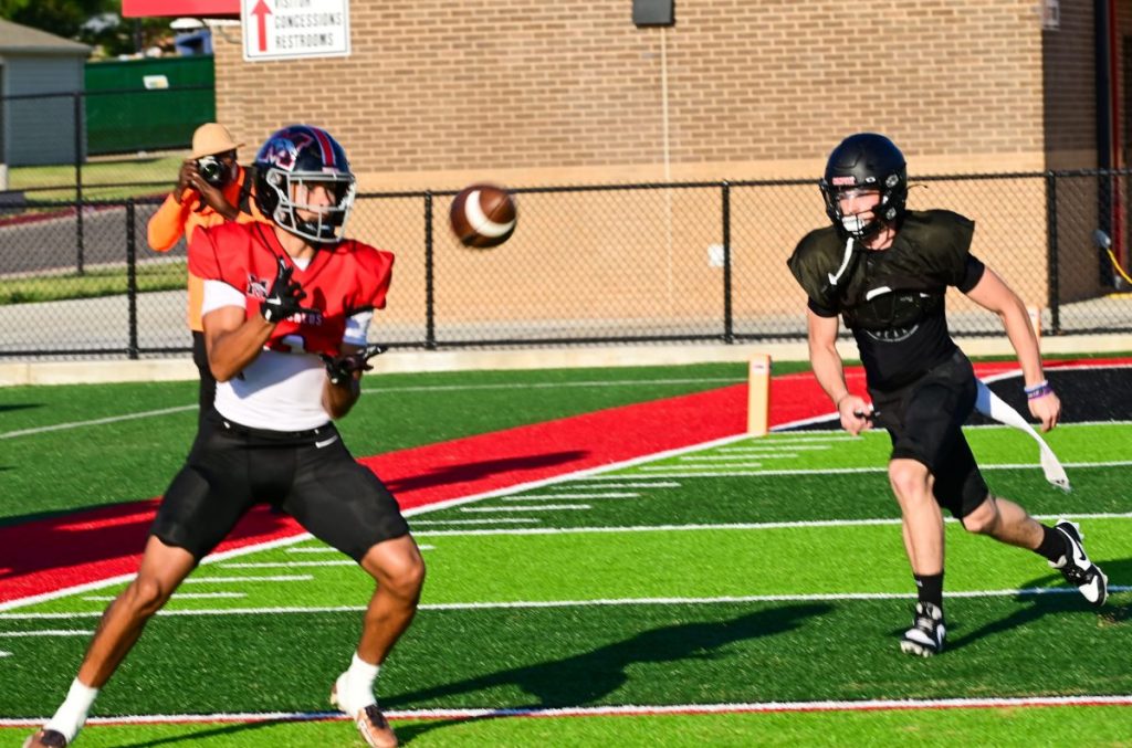 Mustang receiver Jaden Johnson catches a pass during a scrimmage against Westmoore. Photo by Michael Kinney