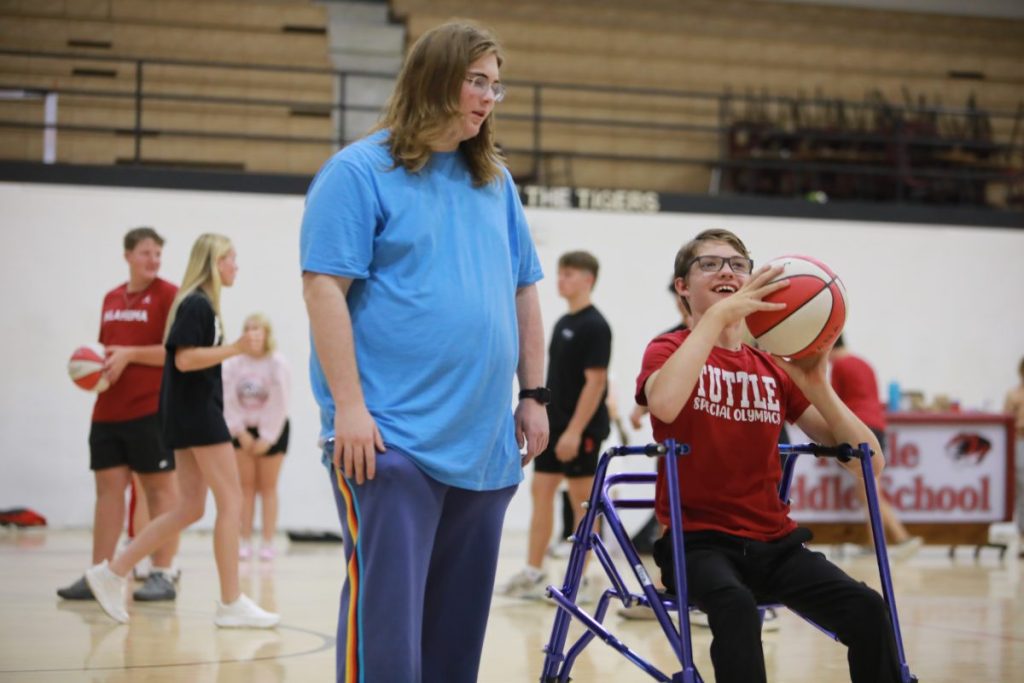 William Thomas hangs out with Austin Hagerman after school Wednesday, October 8 during a practice for the upcoming Unified five-on-five team basketball event November 8, followed by the Boomer Sooner Area Basketball Skills event, which Tuttle will host for the third year, on November 19 from 8 a.m. to noon inside the high school gym. 