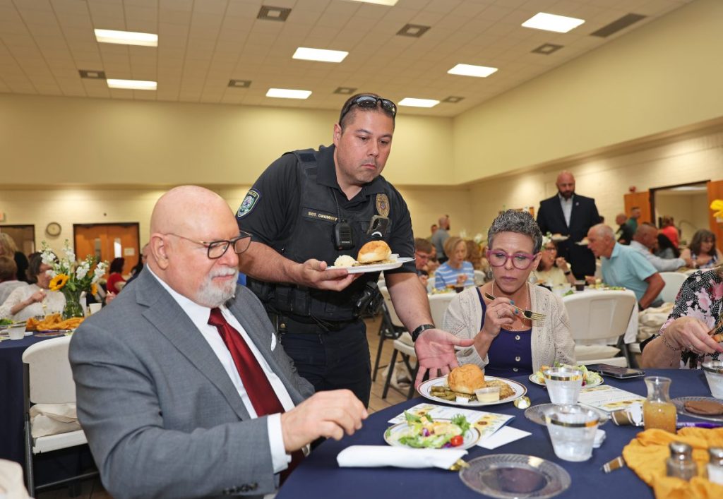 Police officers serve guests at the Leah's Hope luncheon. Photo by Jeff Harrison
