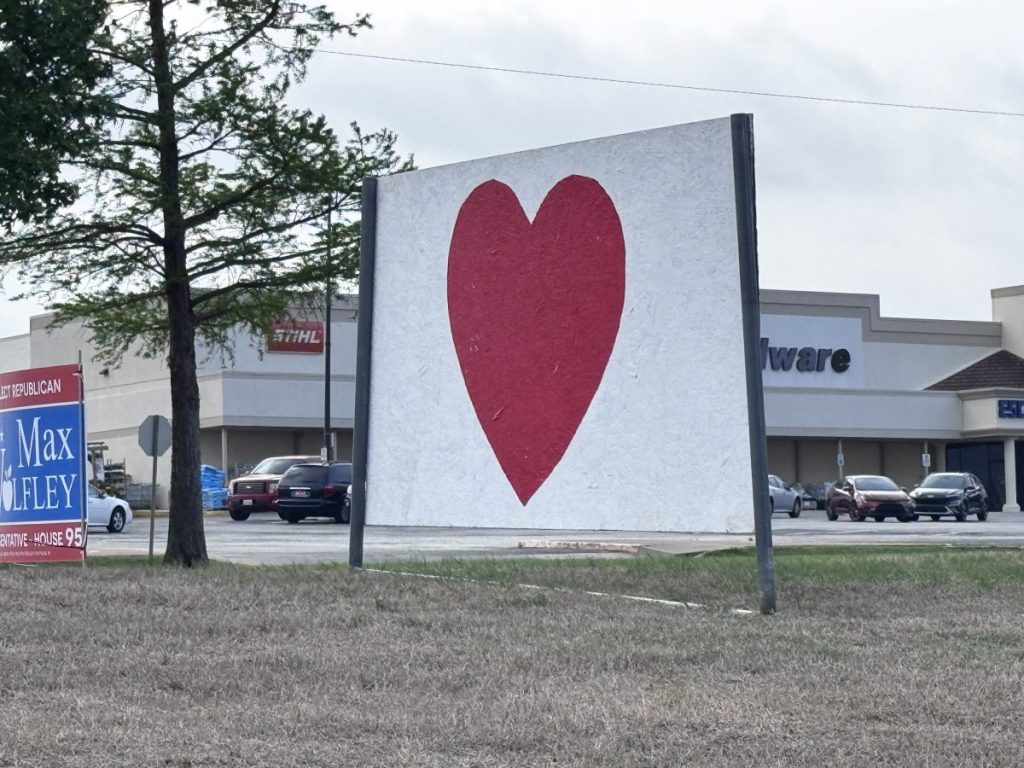 Mysterious red heart signs have popped up around the Midwest City area. Photo by Jeff Harrison